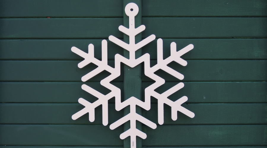 White snowflake on green wooden door