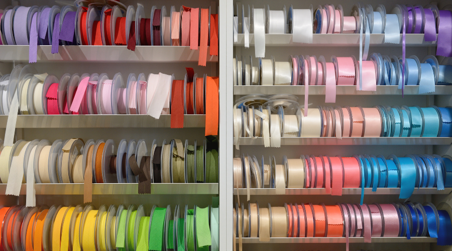 multicolored ribbons for sewing on the shelf
