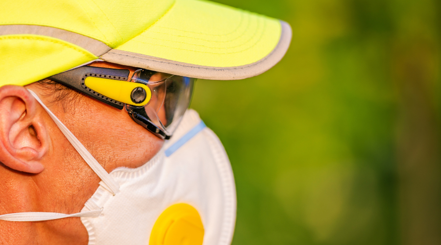man in yellow hat, dust mask, and goggles