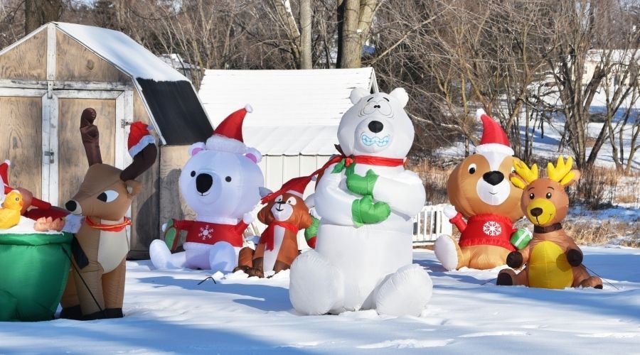 inflatable yard decorations in a snow-covered yard