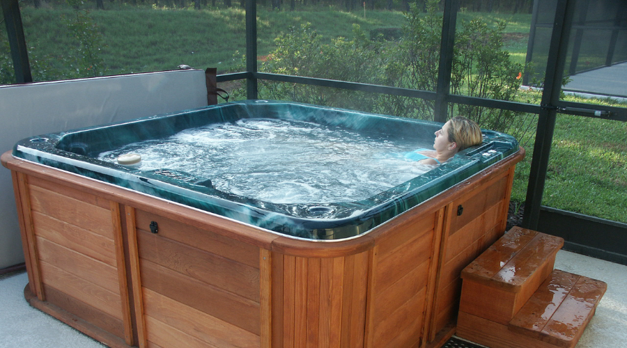 Woman relaxes alone in an indoor hot tub
