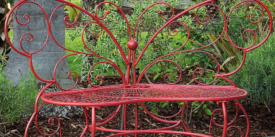 red metal bench in the shape of a butterfly