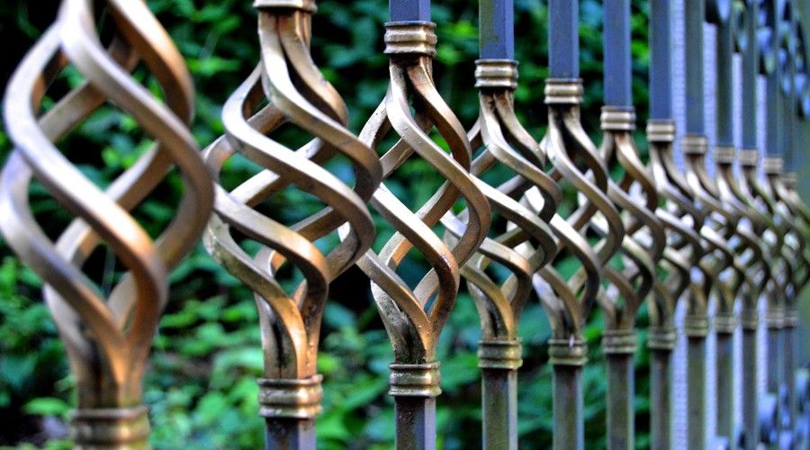 wrought iron fence with gold decorative elements