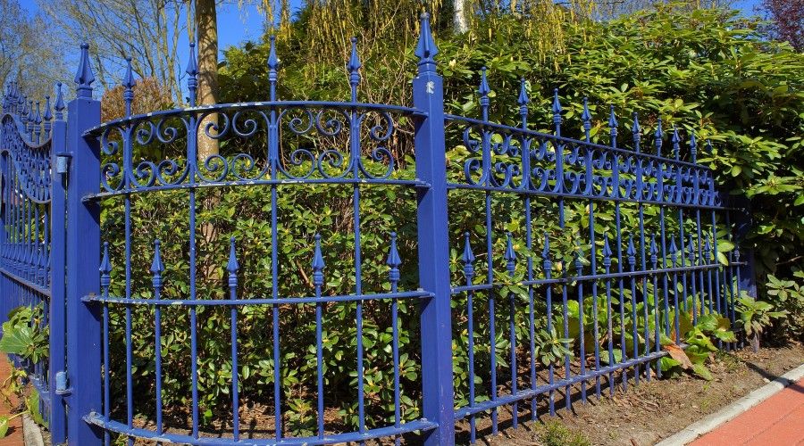 blue-painted wrought iron fence
