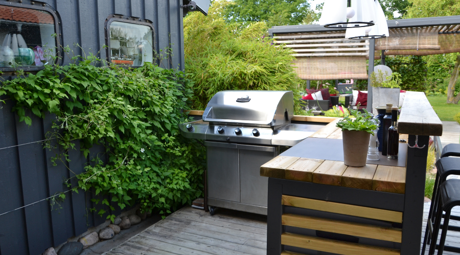 Outdoor kitchen with a stainless gas grill