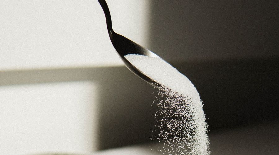 sugar pouring from spoon