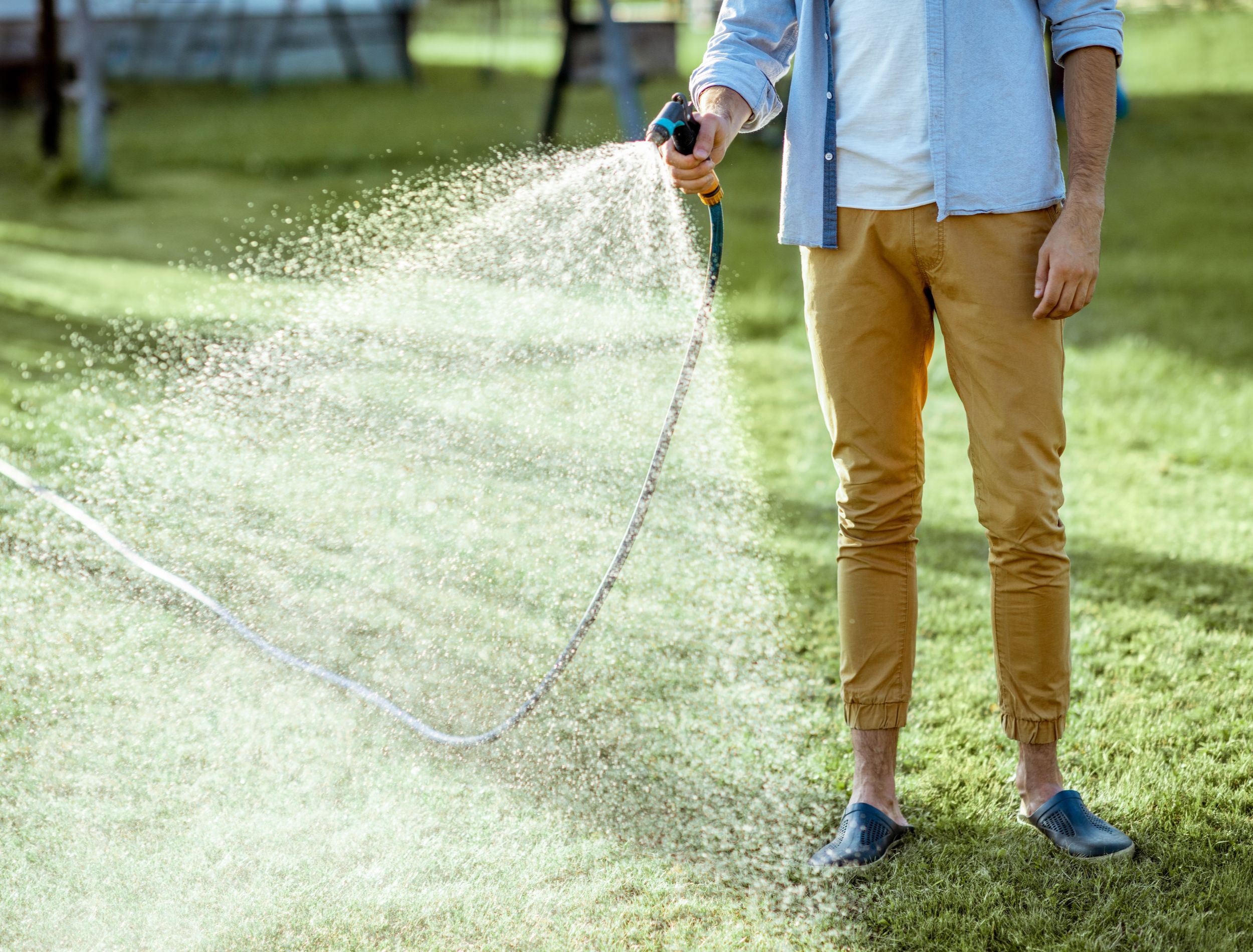 man watering his lawn