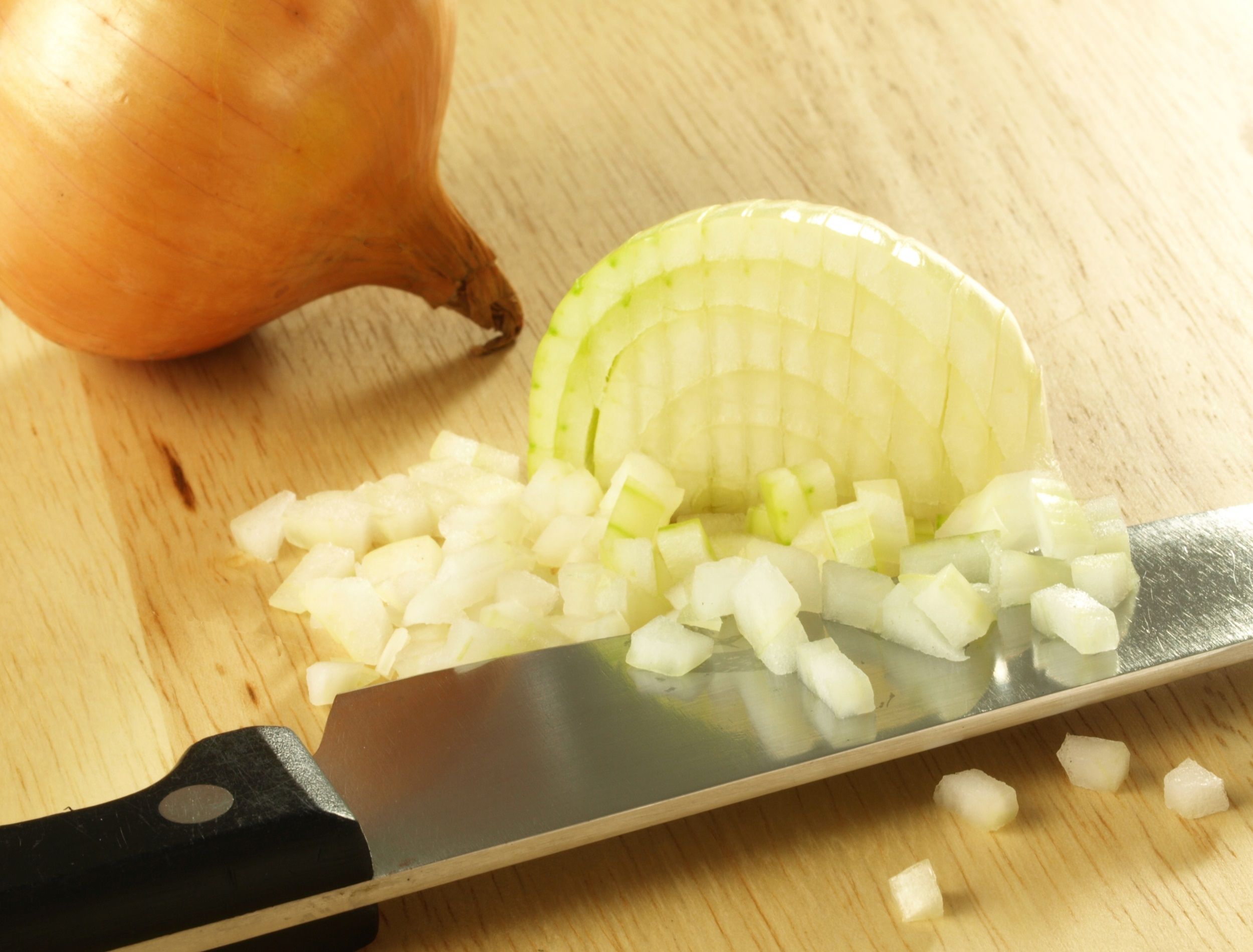 Chopped onion on cutting boarrd