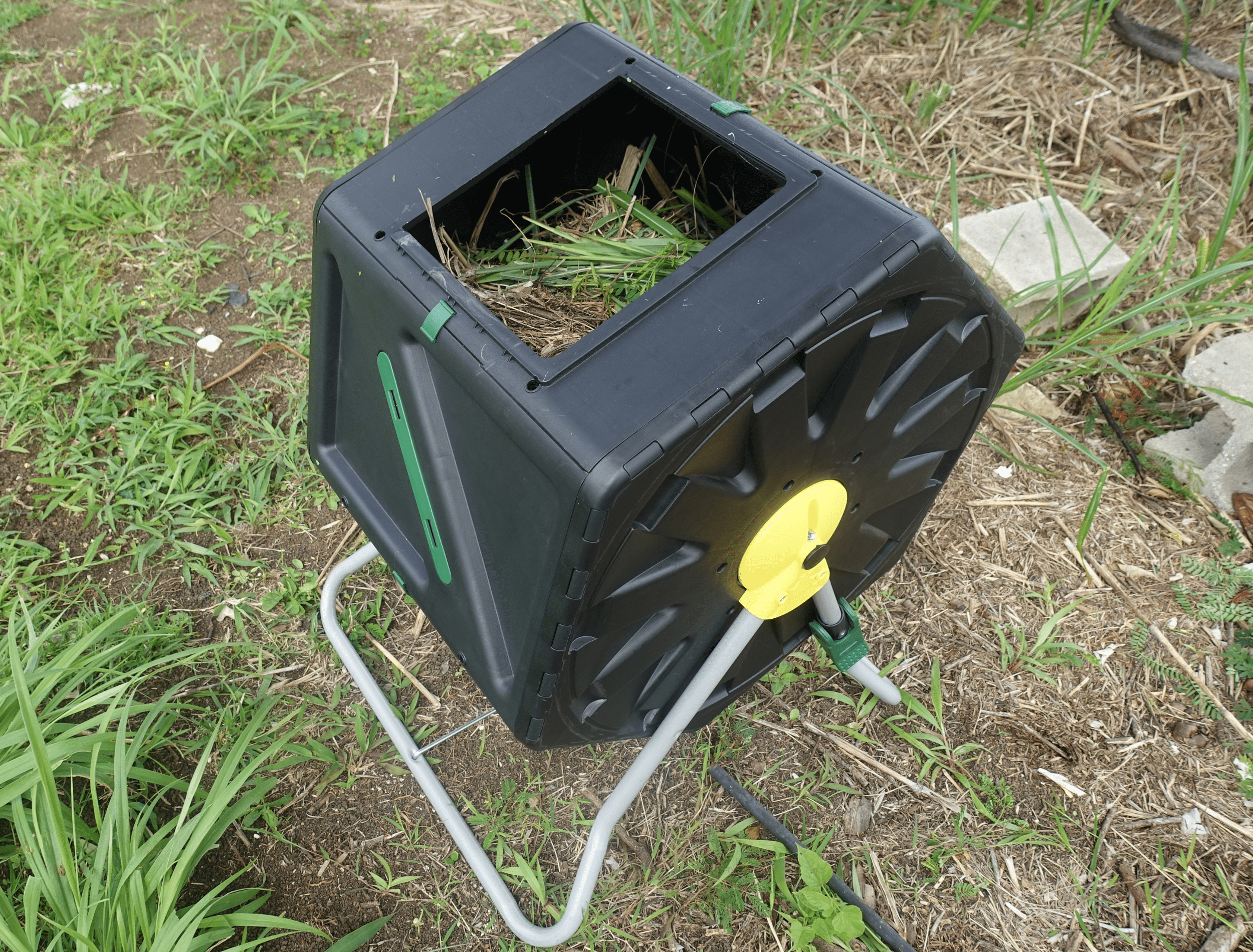 compost tumbler turner full with green and brown material