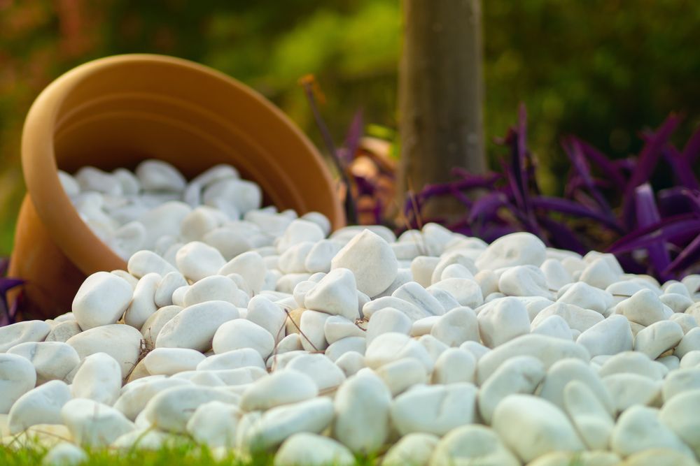 Snow white pebble stones inside a flower pot as a garden decoration