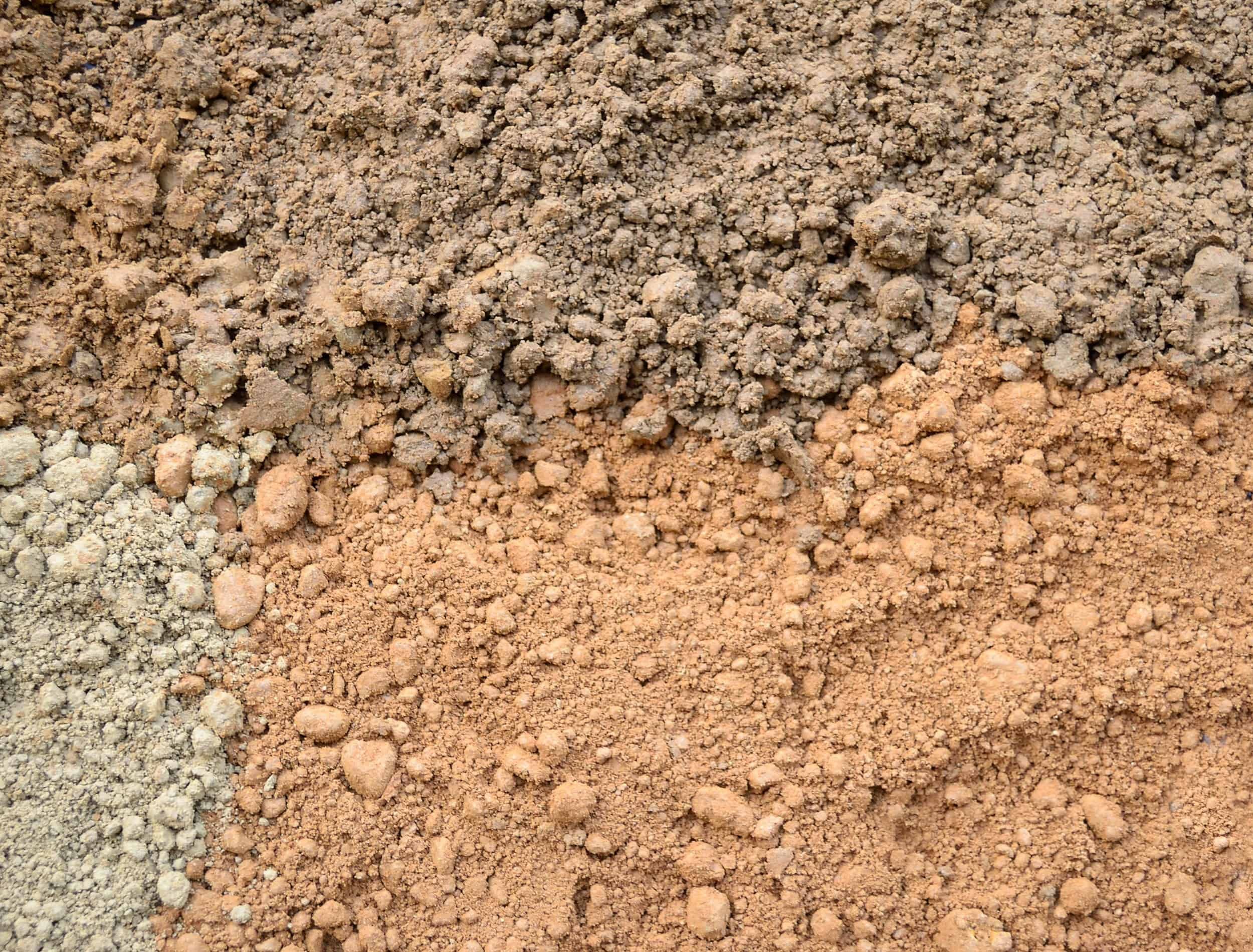 Natural silty soil background: brown, gray and red.