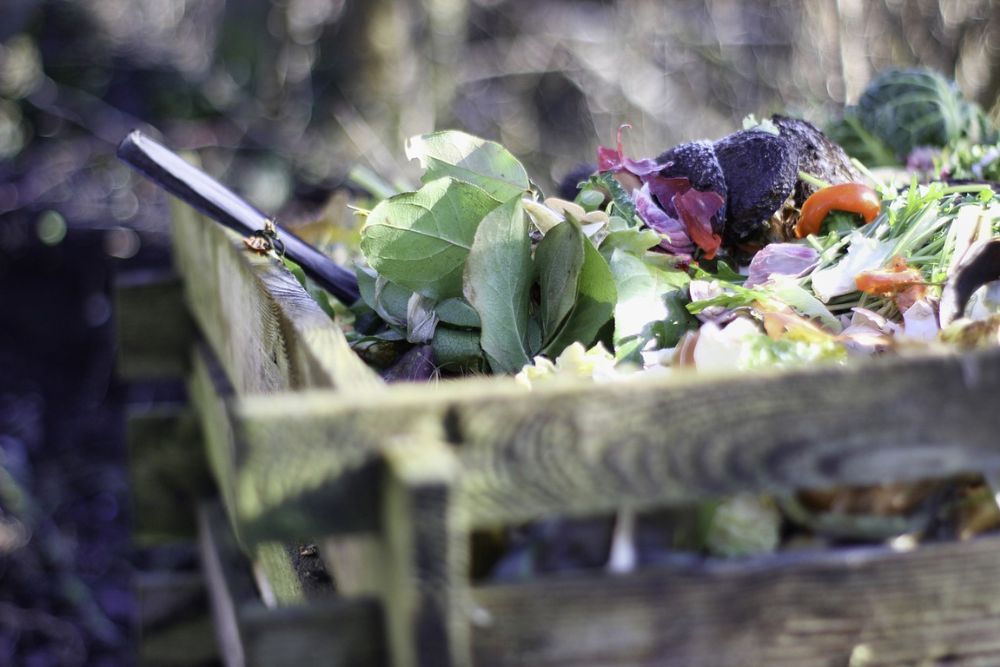 Homemade compost bin with scraps of organic materials in it