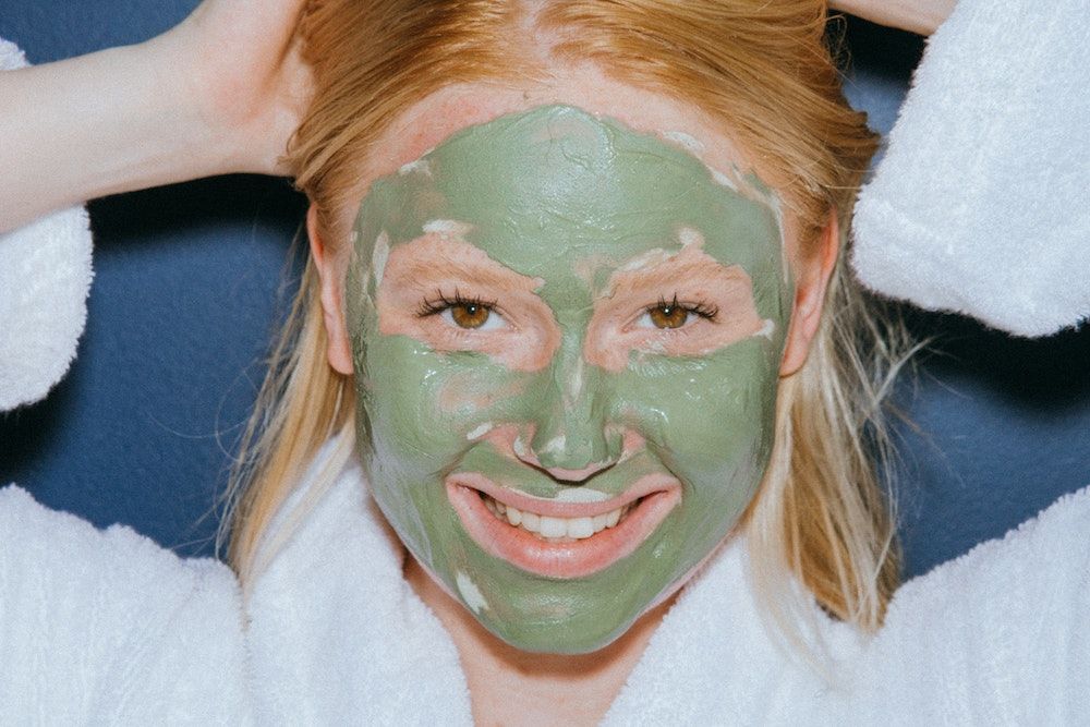 A Woman Wearing Green Mud Mask
