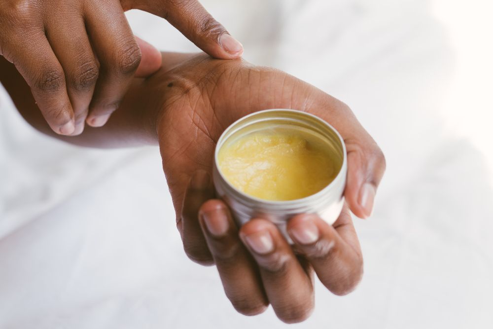 Person holding a yellow cream