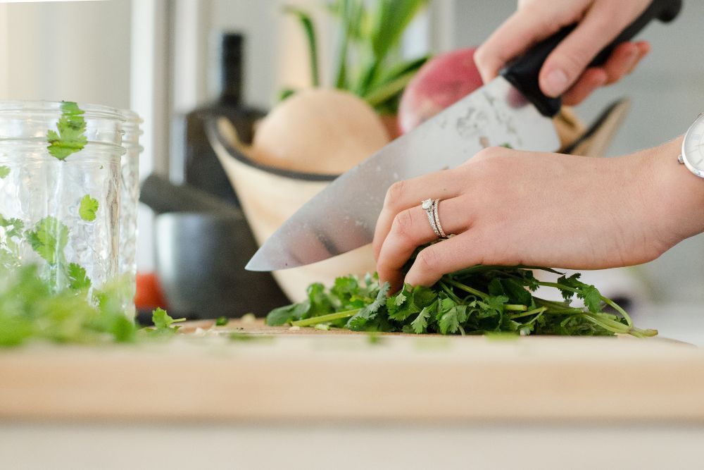 Person chopping up cilantro leaves