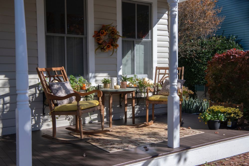 Rocking chairs and a patio table on a front porch