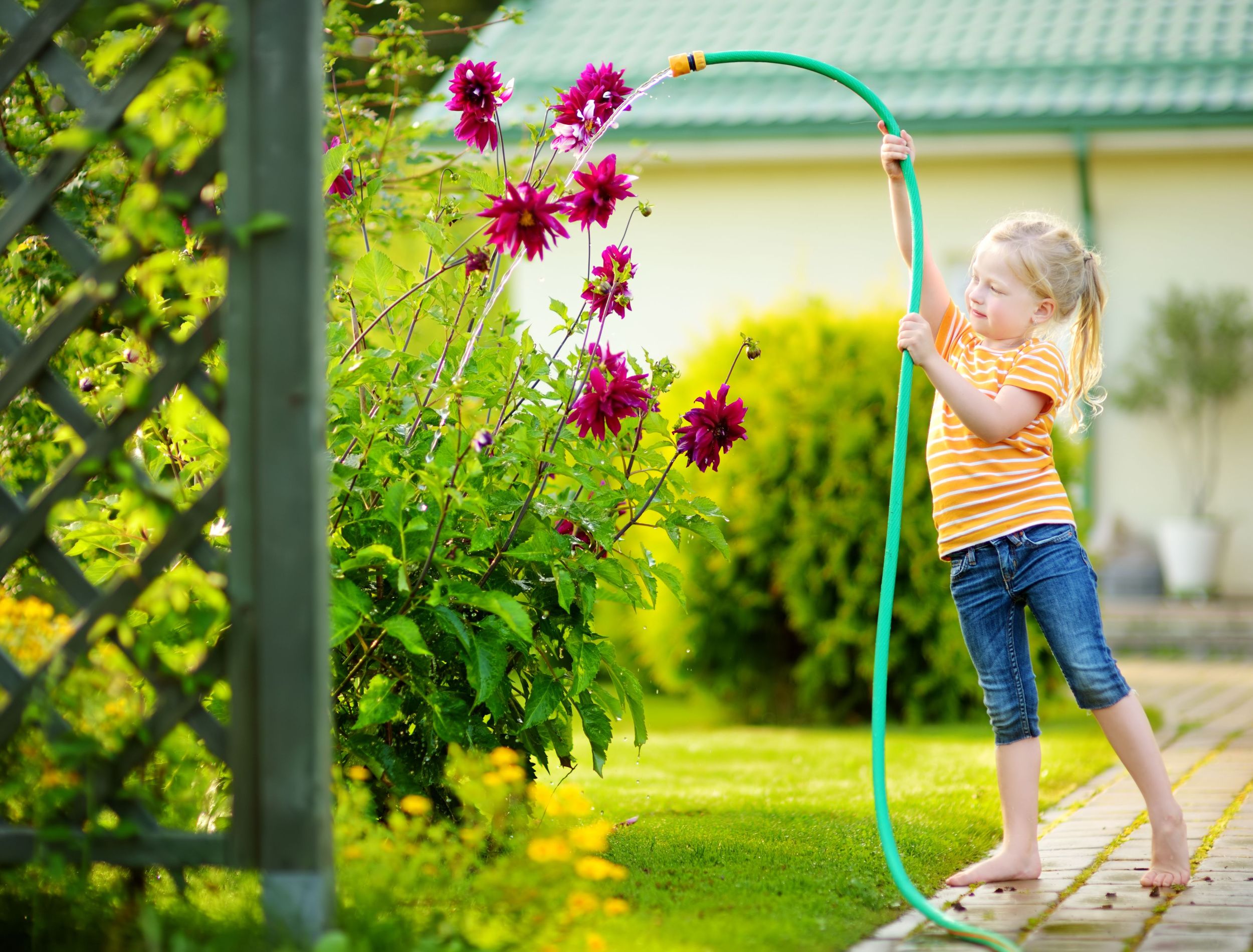 little girl with garden hose
