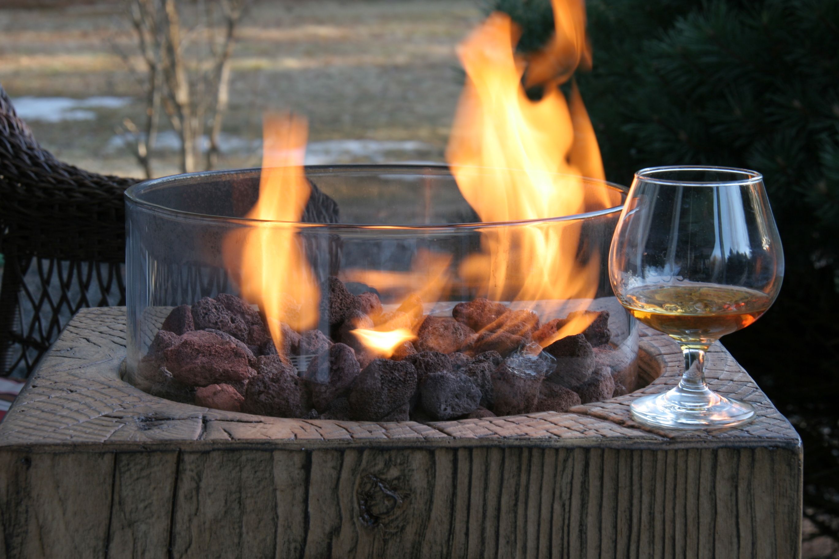 gas fire pit with a snifter of cognac