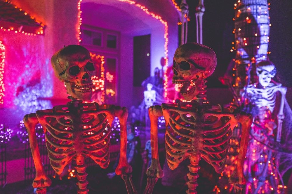 Skeleton decorations on the front porch with lights