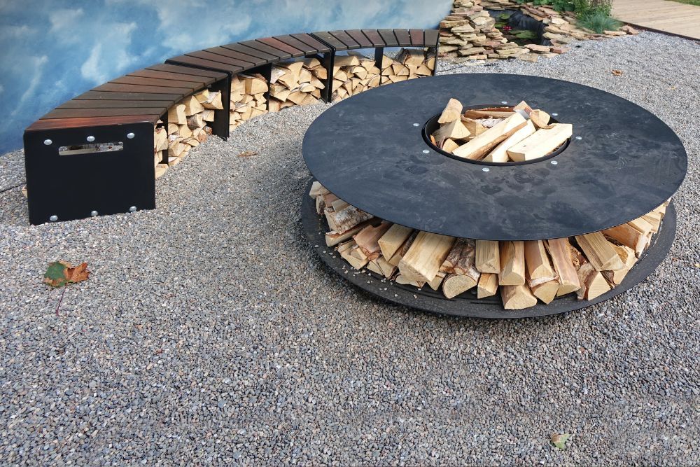 A curved bench near a fire pit