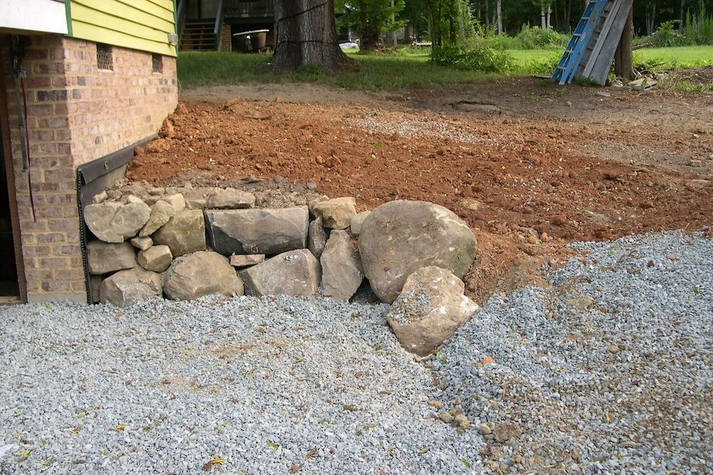 A boulder retaining wall near the house.