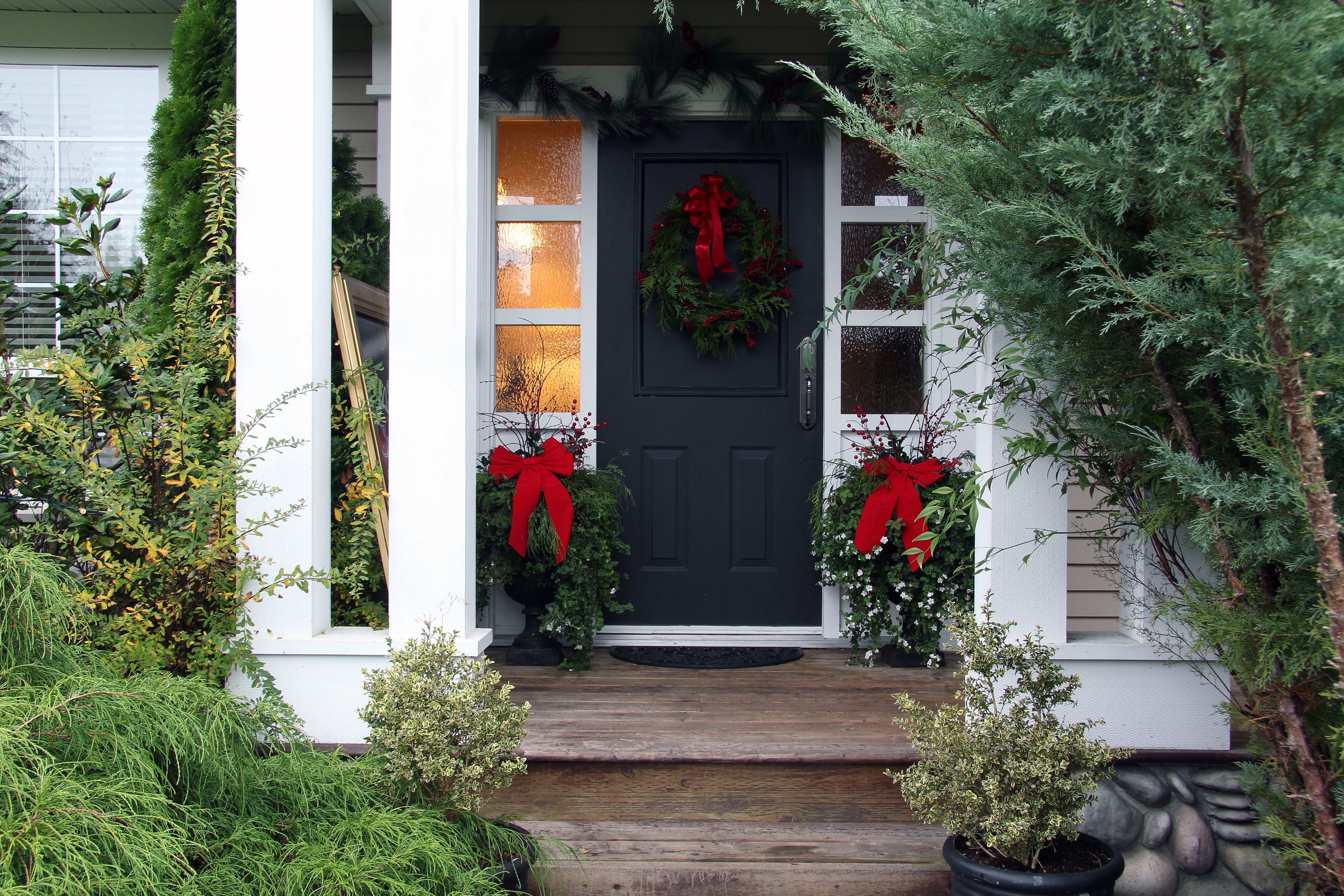 Front door with a Christmas wreath and bows. Also available in vertical.