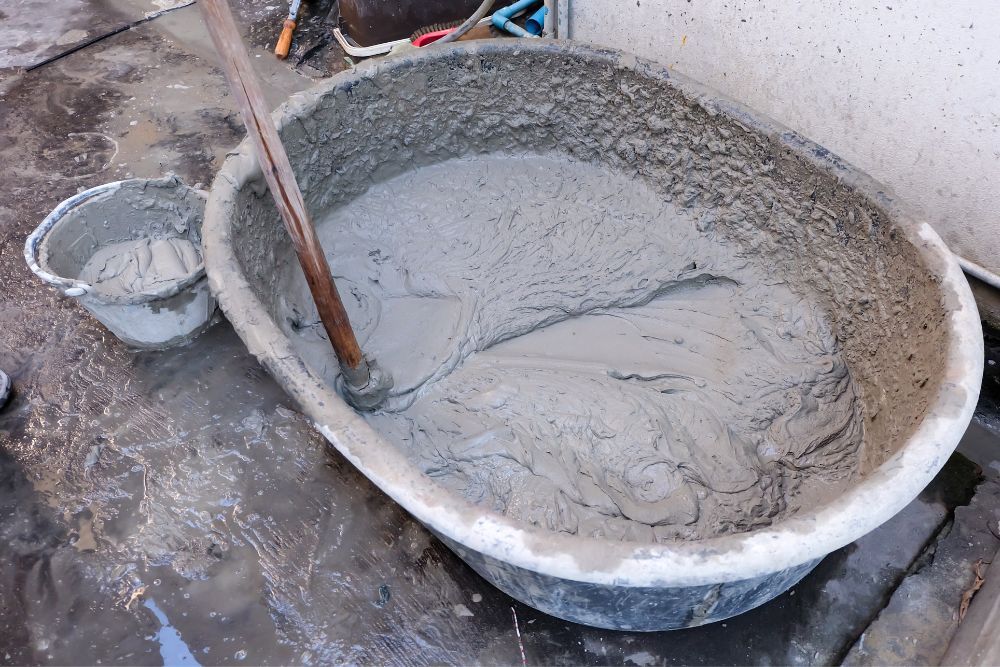 A wheel barrel filled with wet concrete