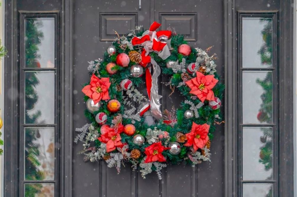 Front door adorned with a poinsettia wreath 