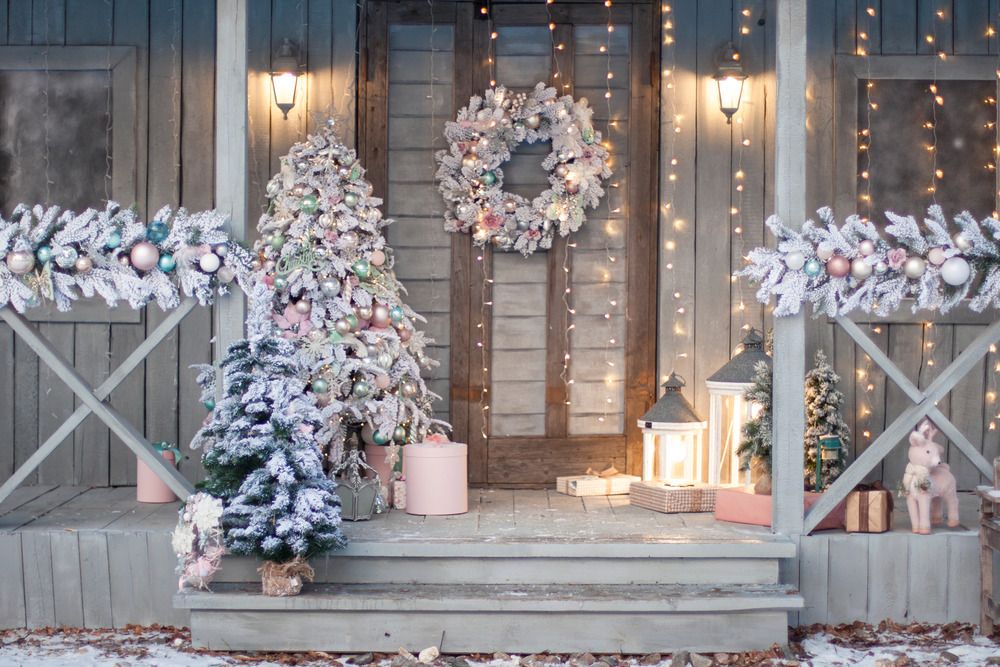 Christmas porch with frosted tree, garland, and pastels