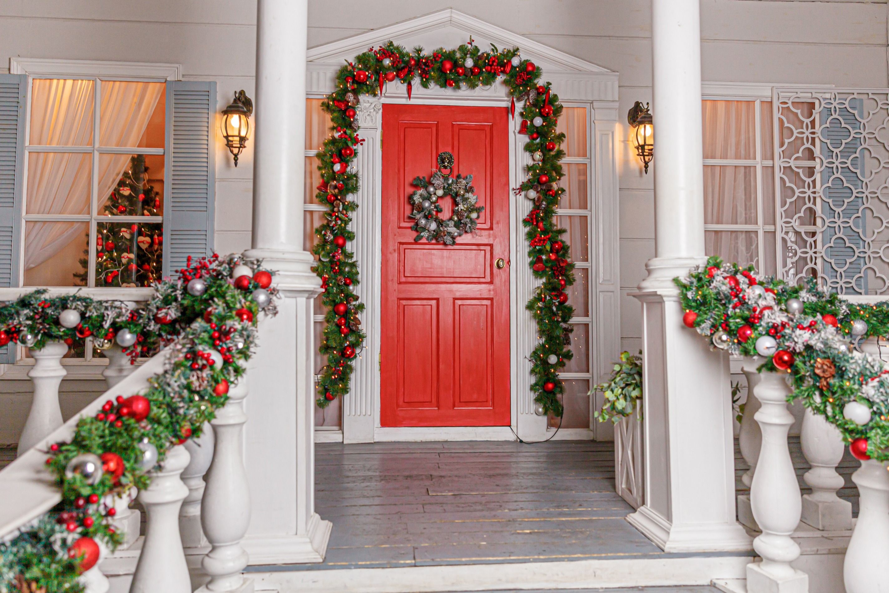 Festive front porch with Christmas bulbs and garland