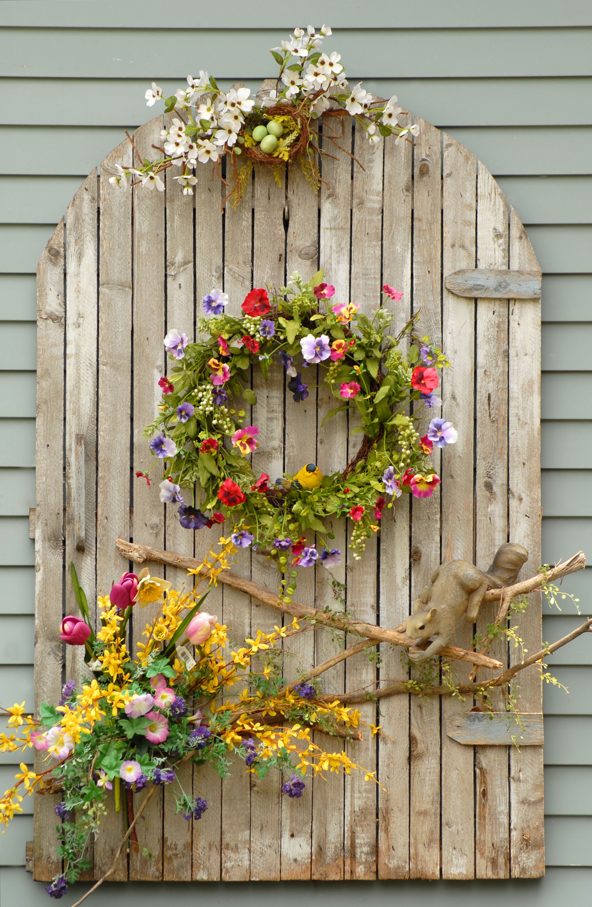 Weather beaten wooden planks with vines and flowers on a wall