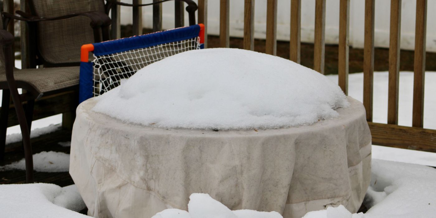 firepit covered with cloth and snow 