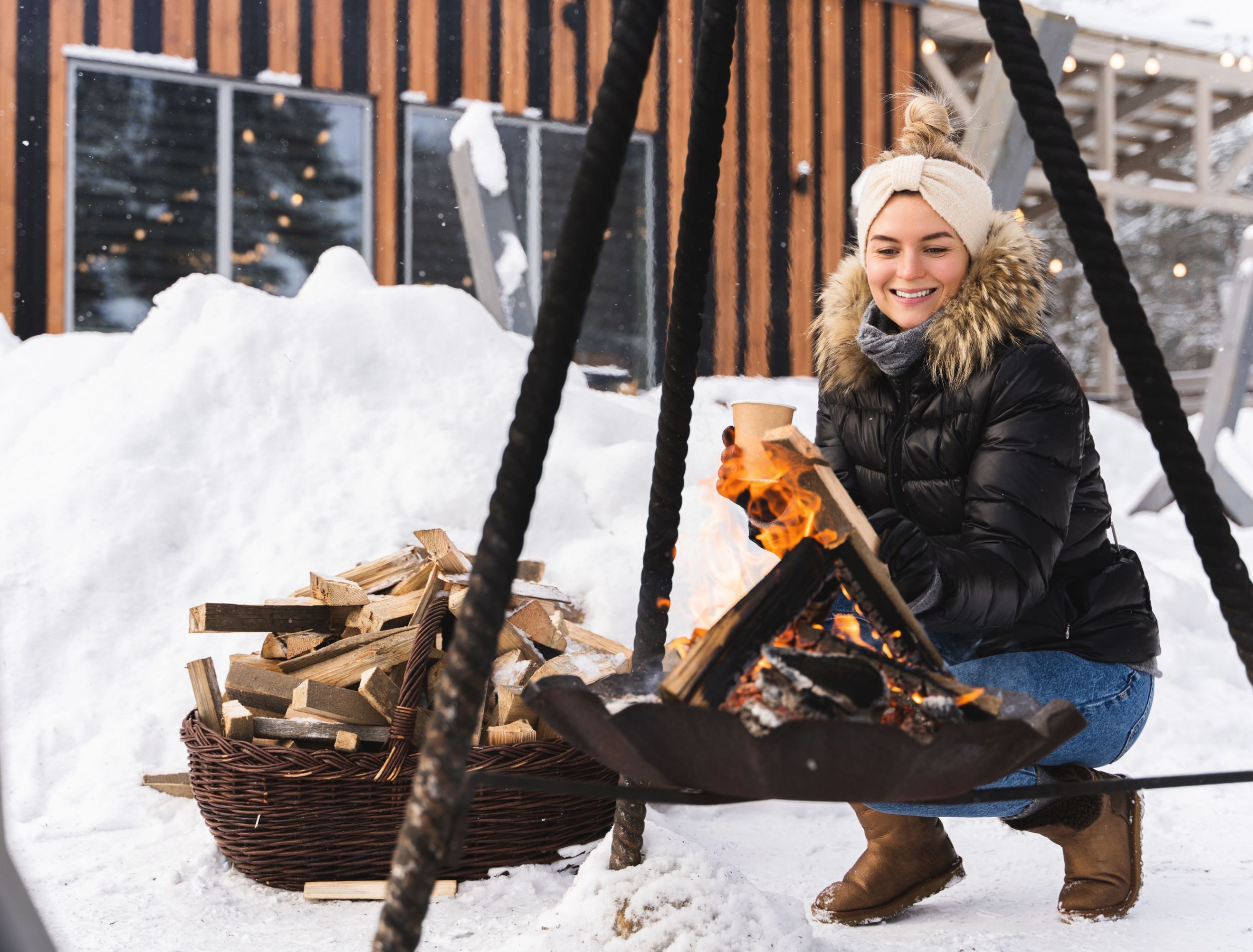 firepit in winter with smiling girl 