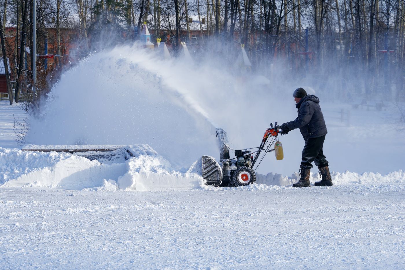An image of a person using a snow blower to clear snow