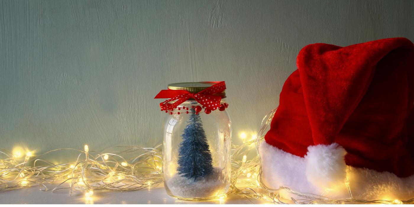 Tree in a mason jar with lights and a santa hat