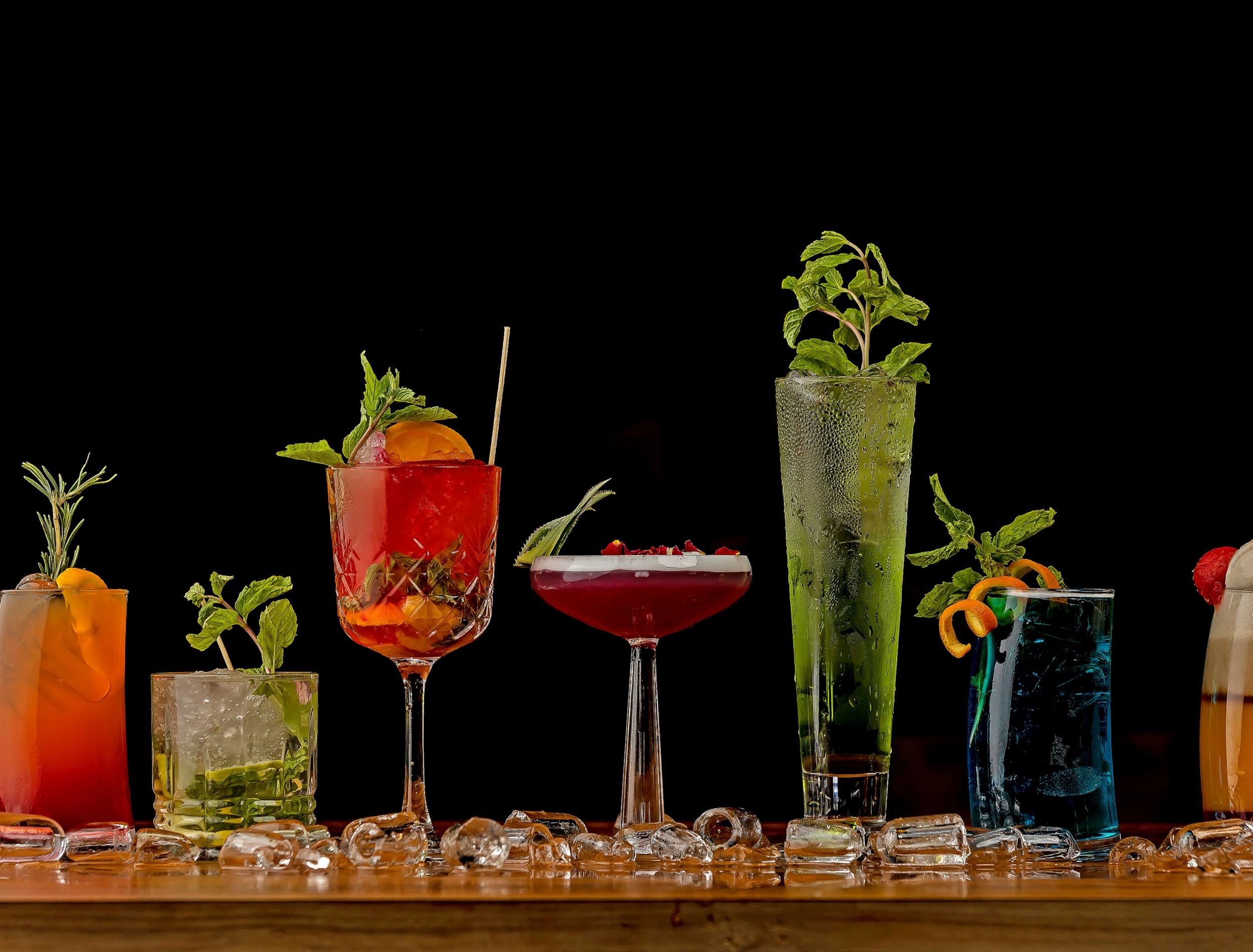 Herbal mocktails on a table with a black background