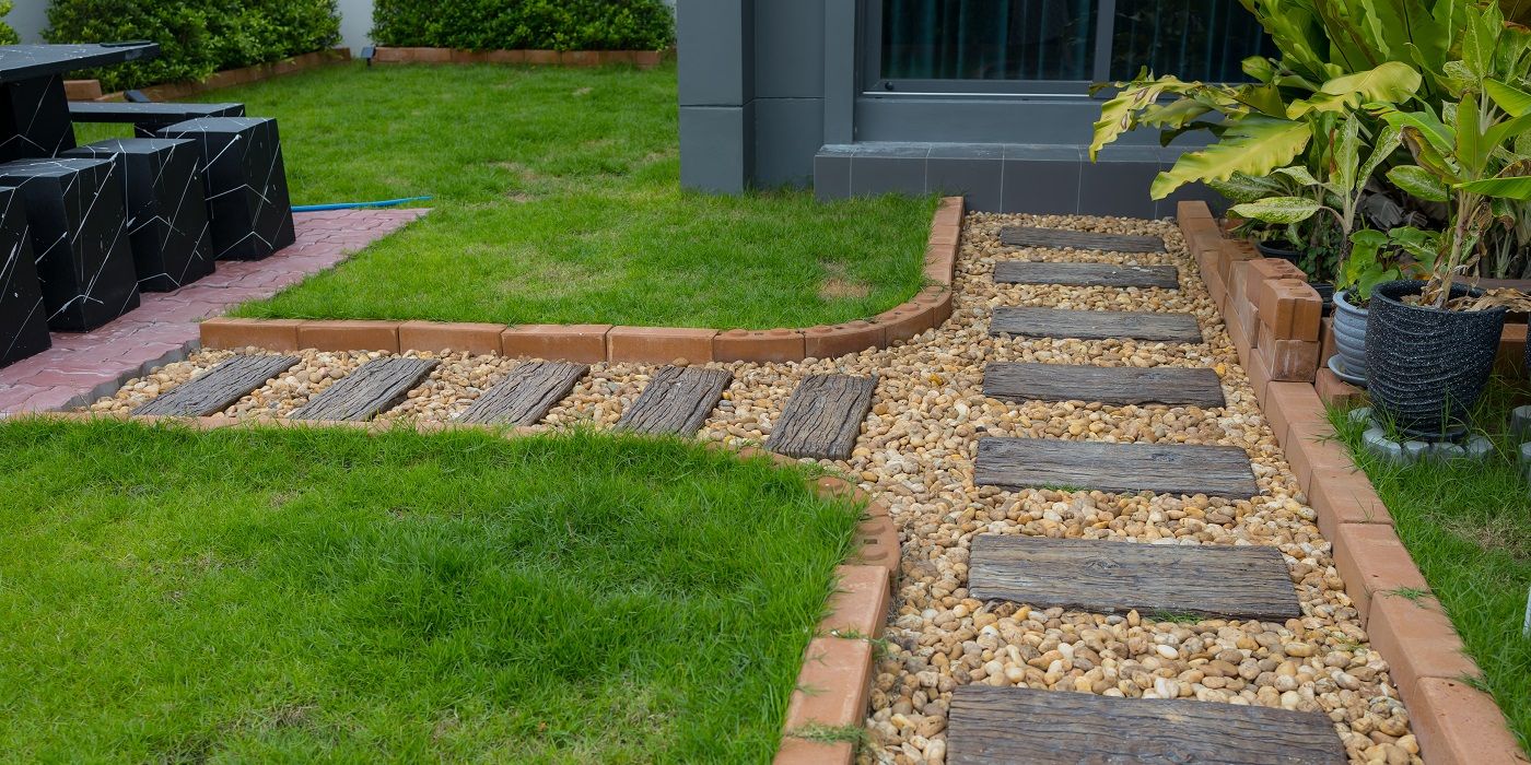 Landscaping edging design with brick and wood