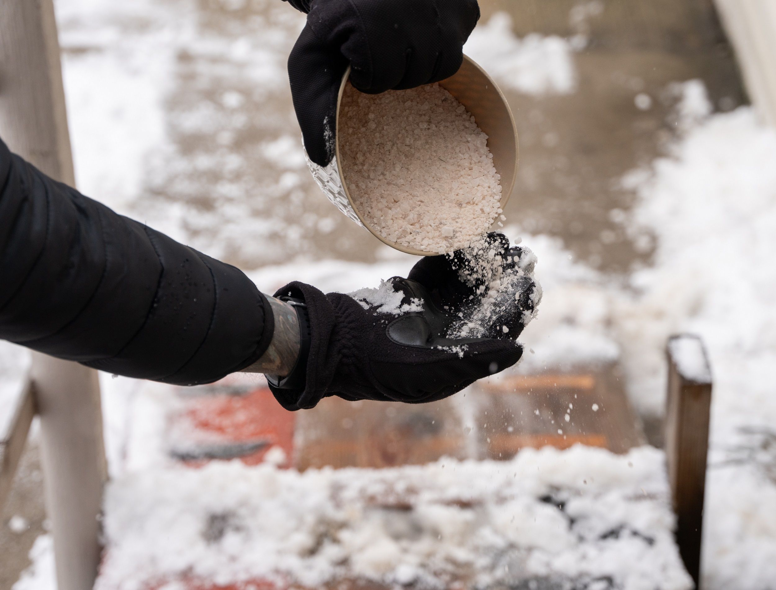 Pouring out Epsom salts to use on icy porch