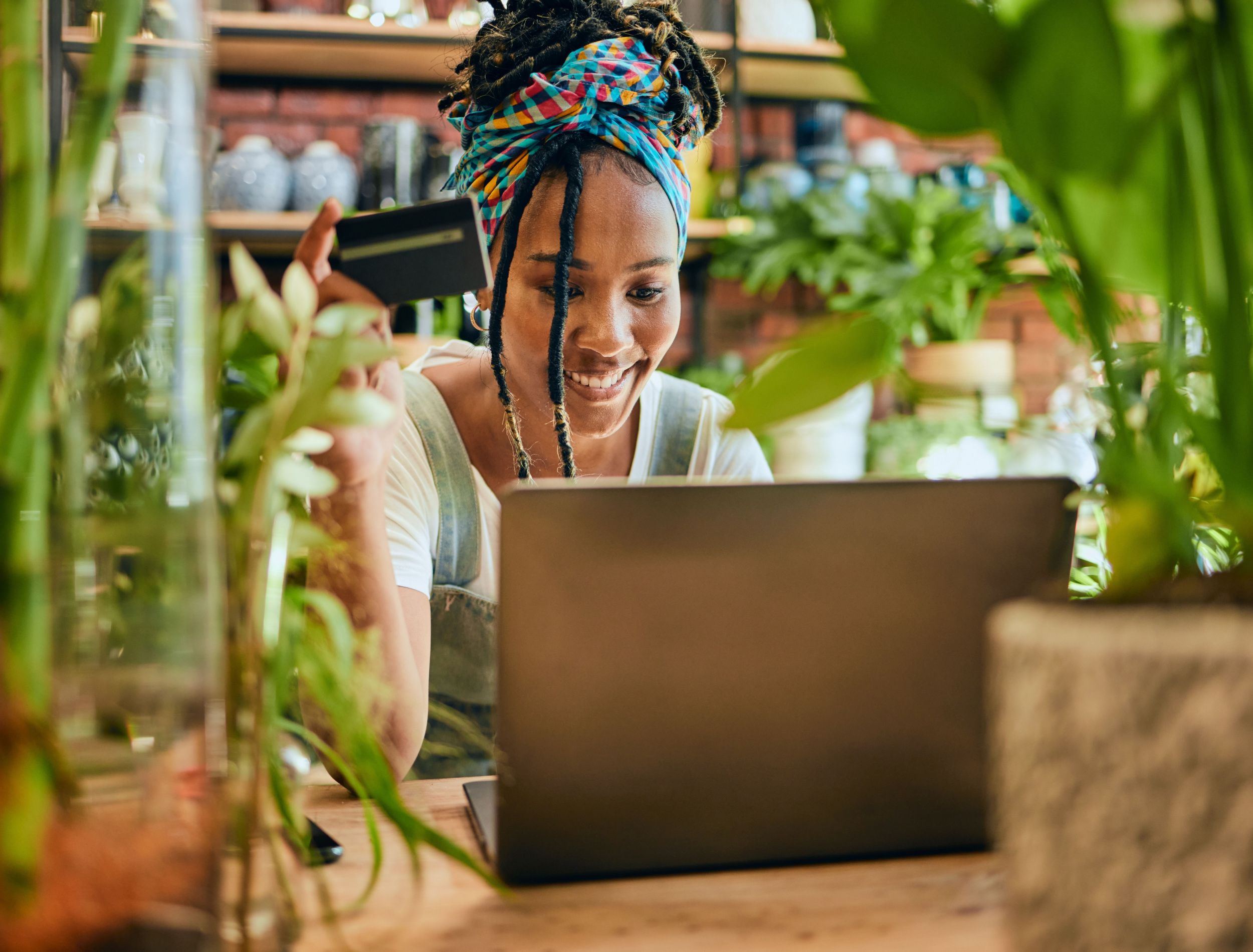 woman on her laptop surrounded by houseplants 