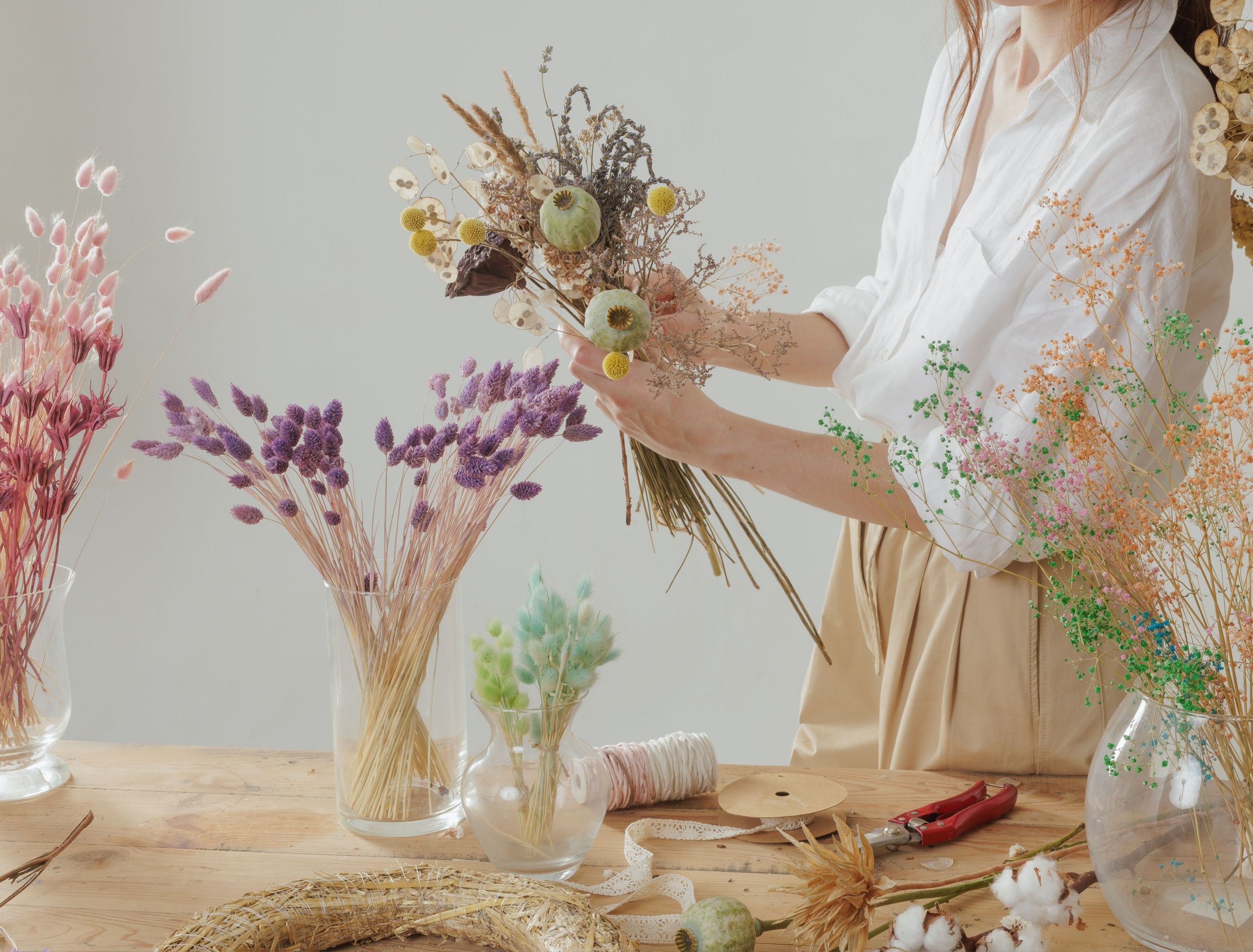 women creating dried flower arrangement