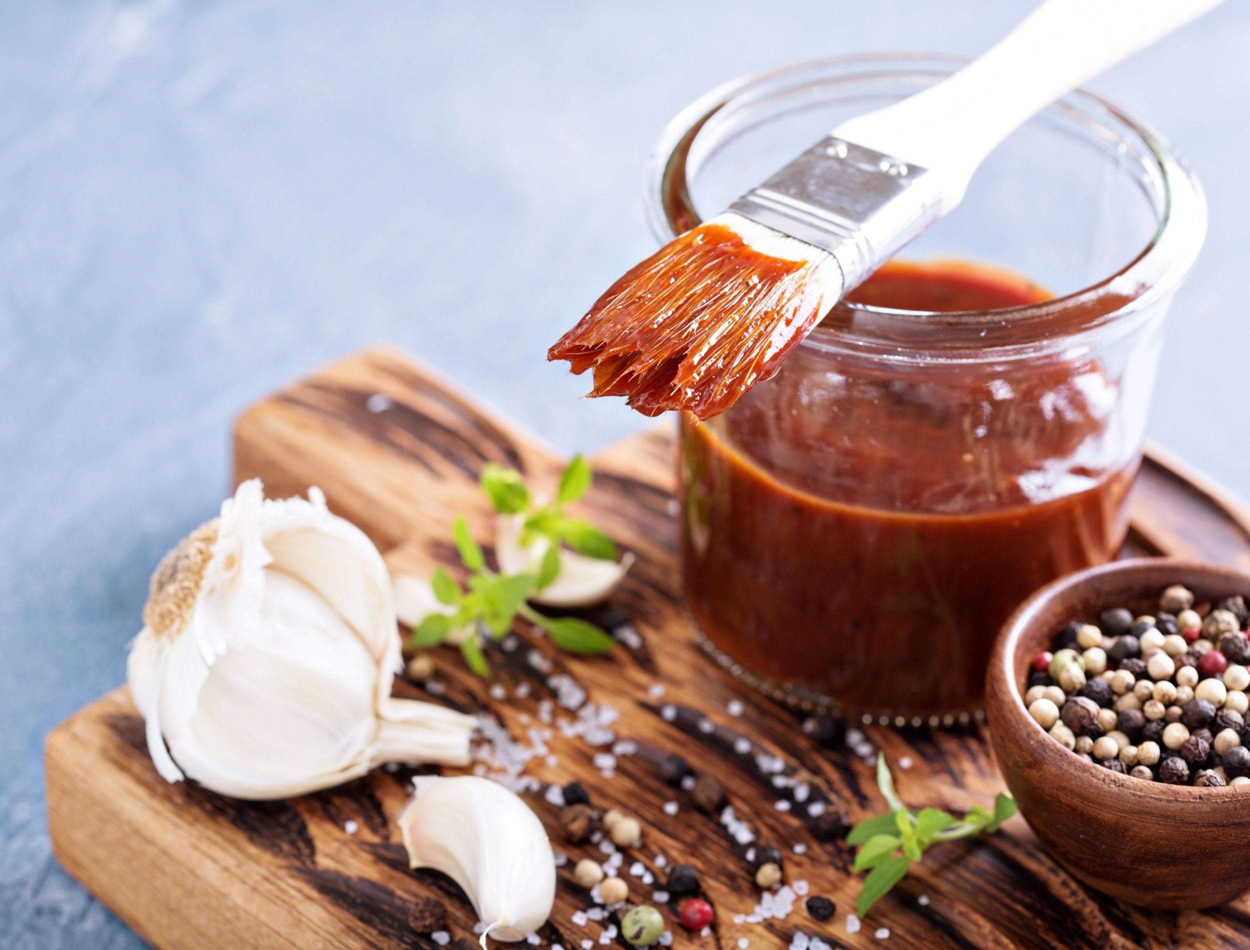 Fresh homemade barbecue sauce with garlic cloves 