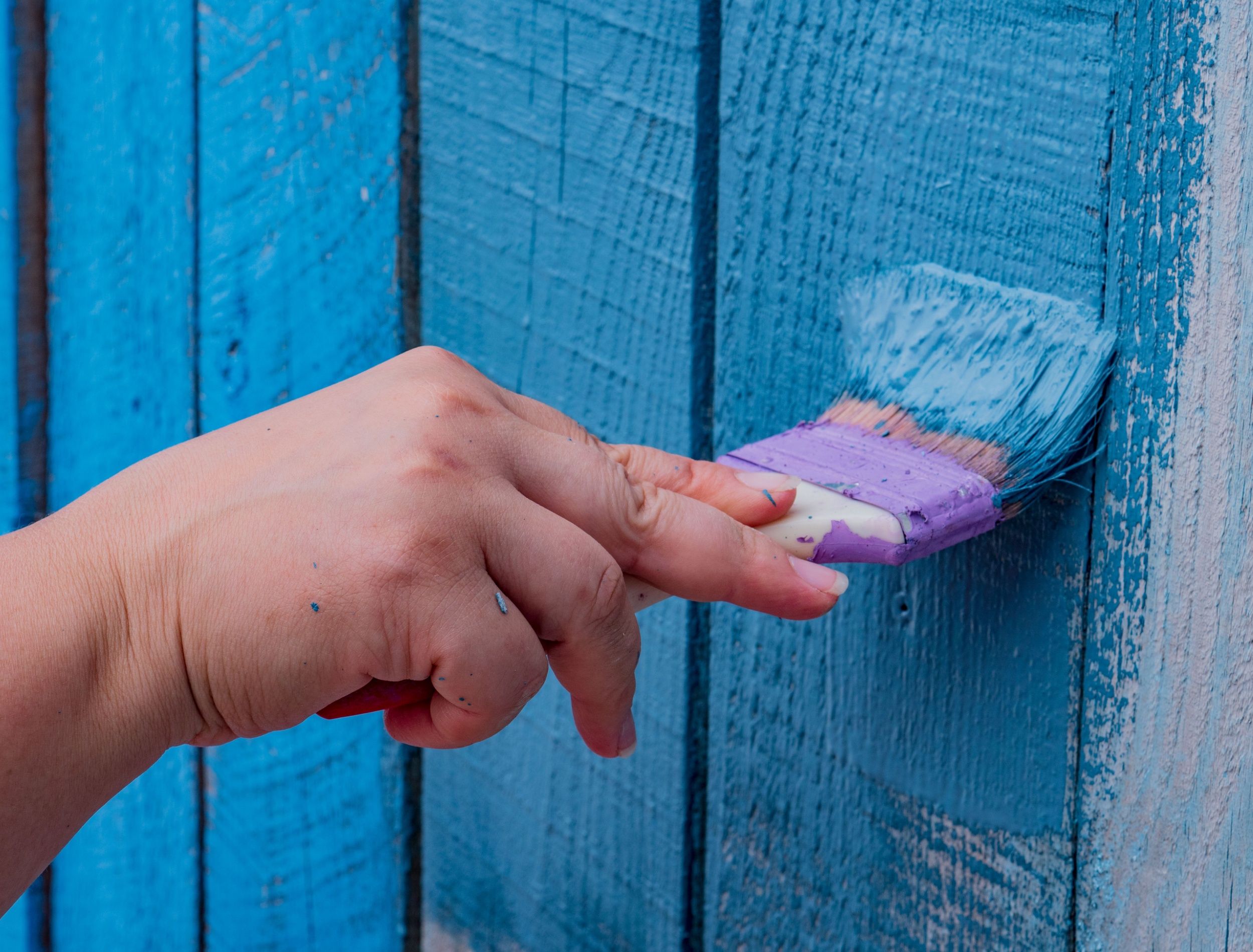 Painting a fence bright blue 