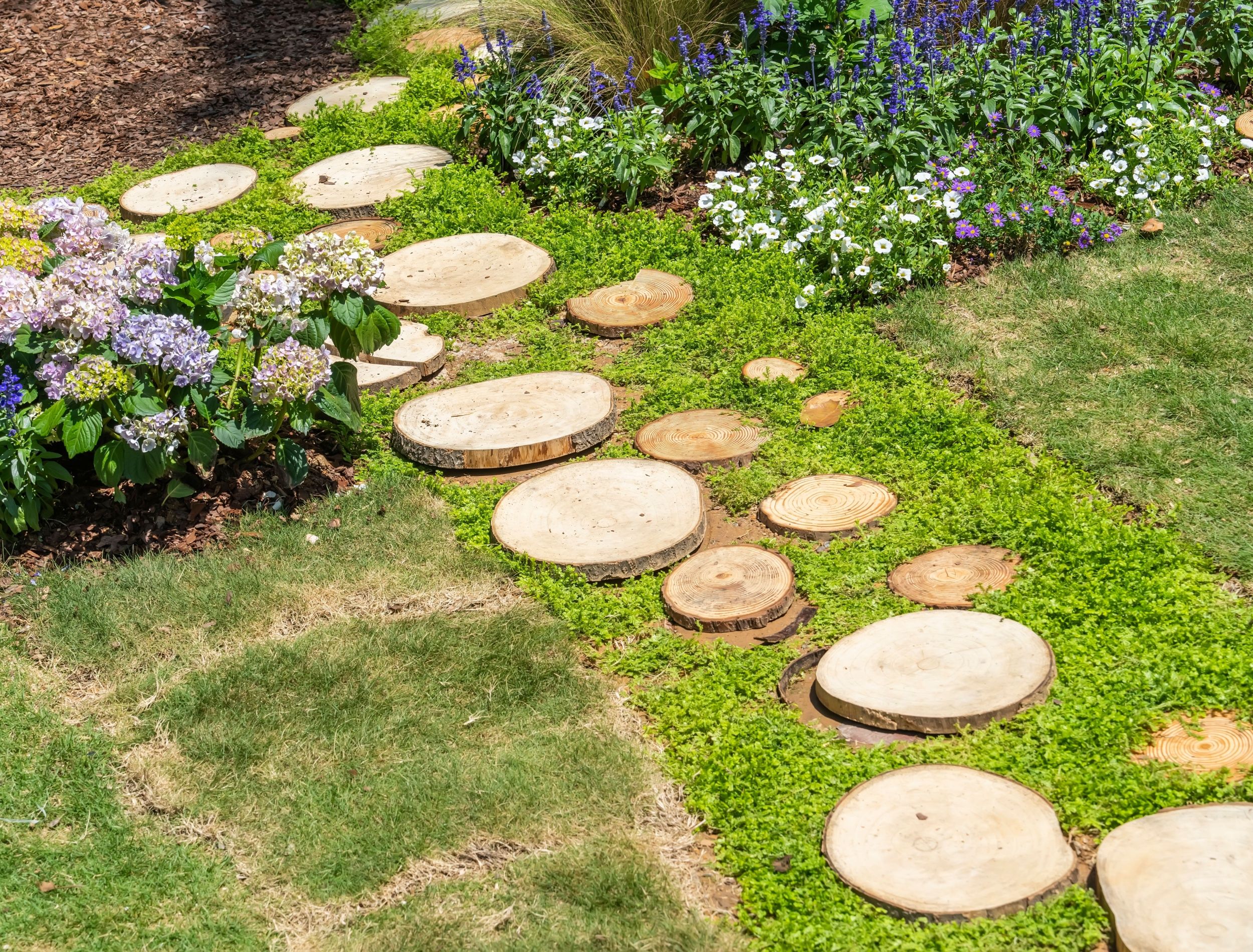 Unique garden path made of tree trunks
