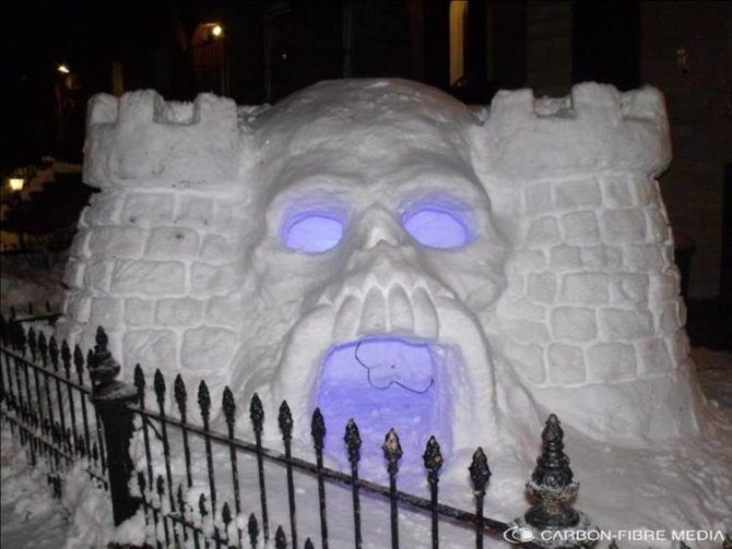 A skull-shaped snow fort with purple glowing eyes and mouth.