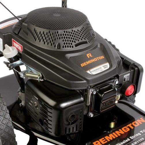 A close-up of a Remington wheeled string trimmer's black and orange gas-powered engine.