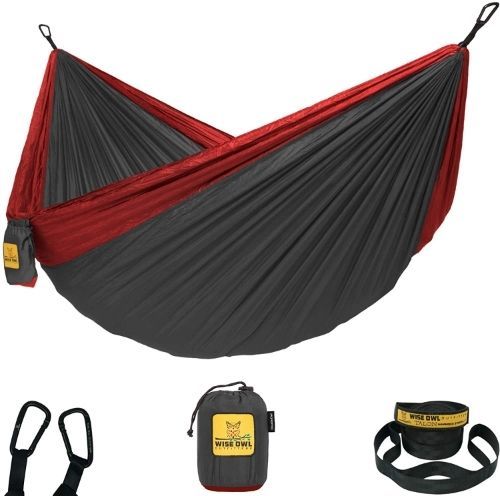 a dark grey and red parachute-style camping hammock with the carabineers, stuff sack and tree straps on display beneath it