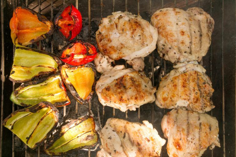 Veggies and meat on a grill grate