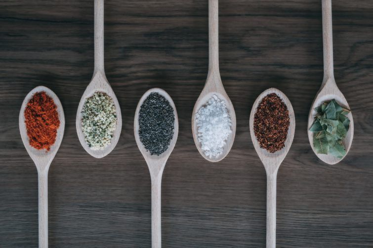 different spices on tablespoons